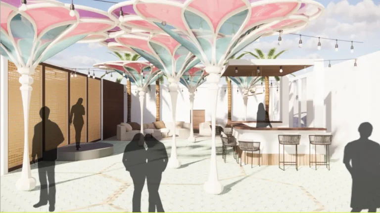 Colorful canopy structures extend overhead, with silhouettes of people standing and walking. The area features a bar with stools, lounge seats, and palm trees, surrounded by white walls.