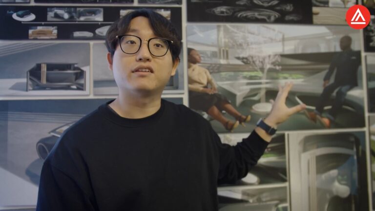 Man explaining design concepts in front of concept art boards.