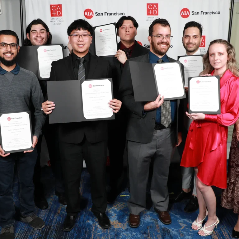 Group of students holding awards at a graduation ceremony.