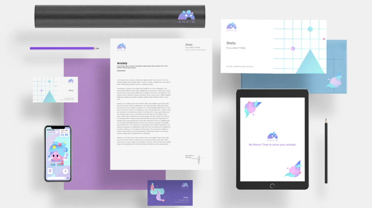 Workspace with digital devices, printed materials, and colorful branding related to anxiety.