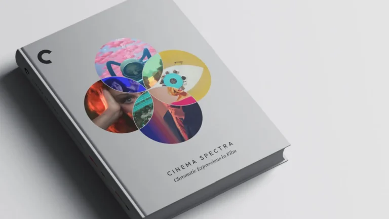 Grey book with colorful circular collage on cover, angled perspective.