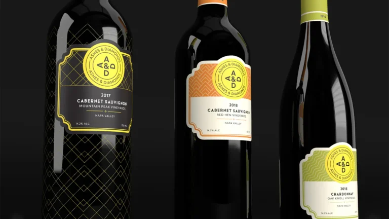 Bottles of A&D wines with ornate labels and dark background display on a row.