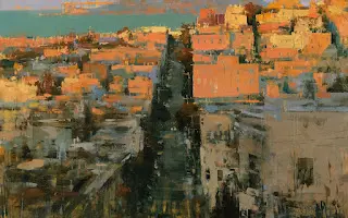 Sunlit hillside town with orange rooftops and narrow central street