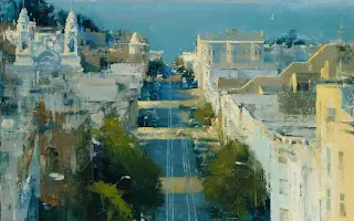 Aerial view of a coastal city with buildings and streets.