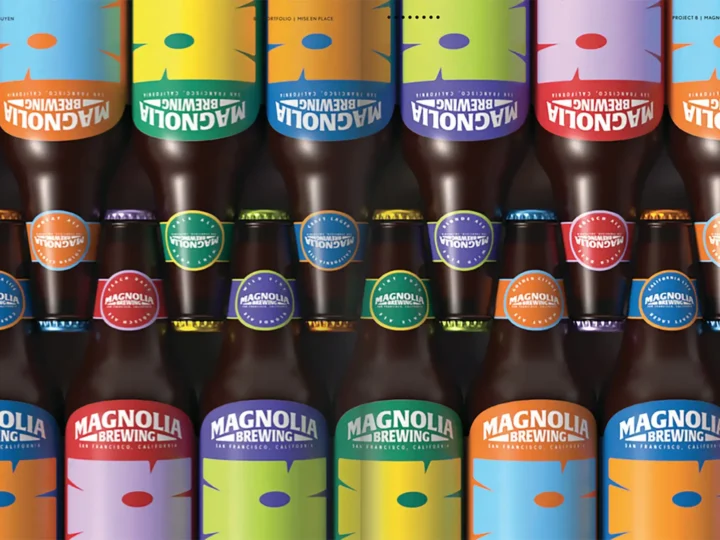 Rows of colorful Magnolia Brewing bottles with bright labels and caps