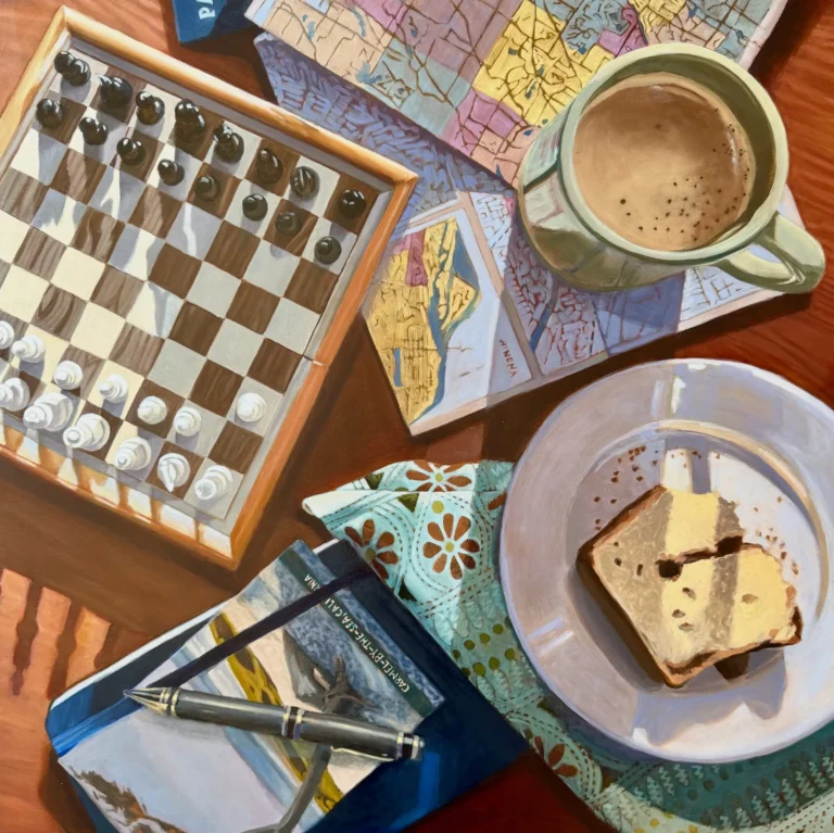 Out-of-focus desk with chessboard, notebook, pens, and a mug of coffee close by