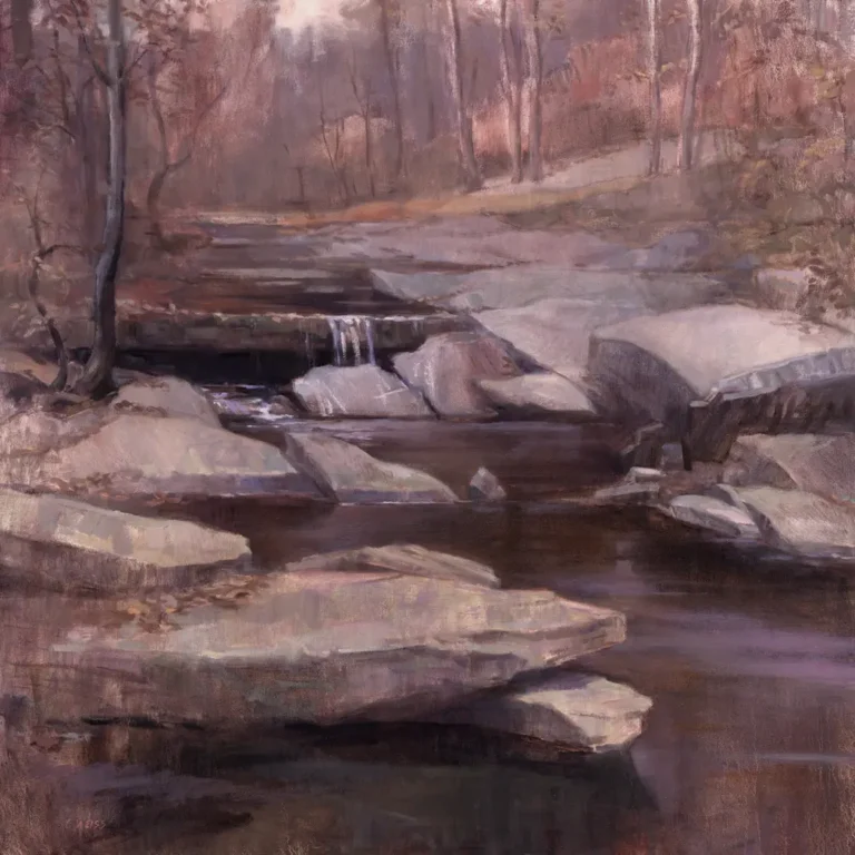 Autumnal creek with large flat rocks and small waterfall in a forest
