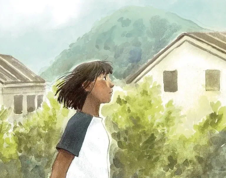 A girl with short dark hair looks up in a garden between houses.