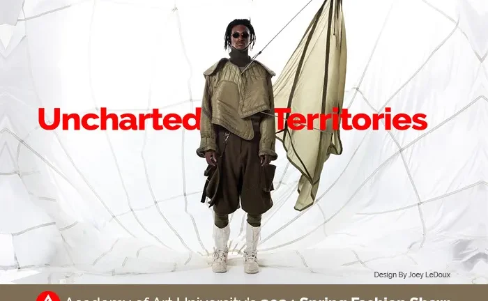 A person stands in a unique, layered outfit with draped fabric, set against a white, geometric backdrop. Text reads 