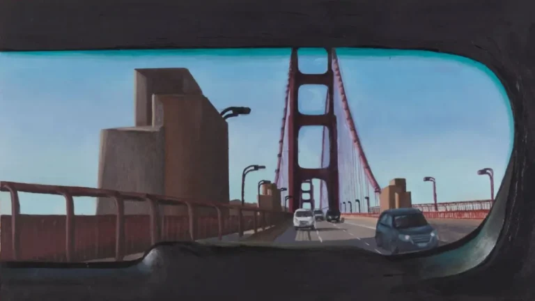 A bridge viewed from a car window frames a distant cityscape, as vehicles drive across under a clear blue sky.