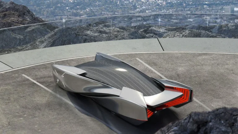 A sleek, futuristic car rests in a mountain-top parking space, with panoramic city views visible beyond the transparent safety barrier, under a clear sky.