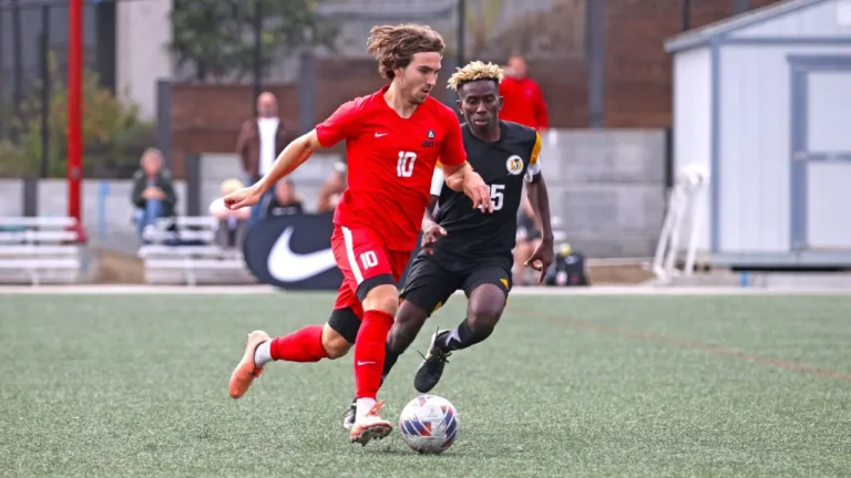 A soccer player in a red jersey marked 