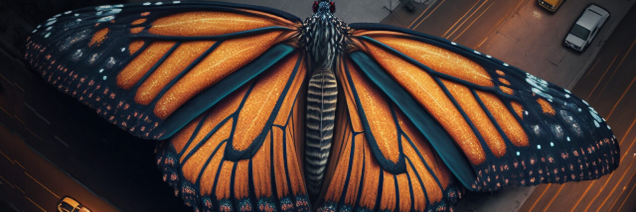 A giant, vividly colored butterfly with outstretched wings hovers above a nighttime city street, where cars and taxis are driving below.