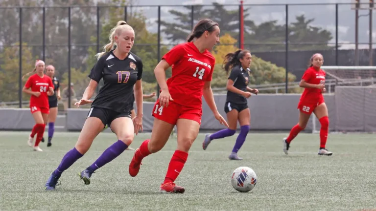A soccer player in a red jersey labeled 